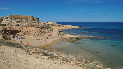 Cove in the Cabo de Gata-Nijar natural park with the castle of San Ramon in background, el Playazo...