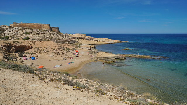 Cove in the Cabo de Gata-Nijar natural park with the castle of San Ramon in background, el Playazo de Rodalquilar, Mediterranean sea, Almeria, Andalusia, Spain