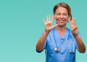 Middle age senior nurse doctor woman over isolated background showing and pointing up with fingers number eight while smiling confident and happy.