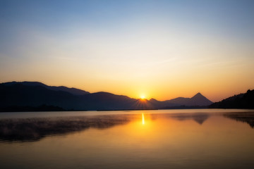 Fototapeta na wymiar Wonderful the lake with sunrise in the evening. attractively nature landscape of golden lake and lagoon. image for background, wallpaper, copy space, decorate and arts.