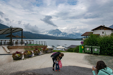 Candid photo of a mother and her daughter and sister at lake Santa Croce Italy 