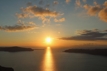 The sun setting over the sea in Santorini, Greece