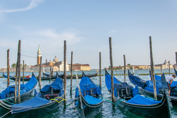 Fototapeta na wymiar View of some fascinating docked gondolas in Venice Italy 