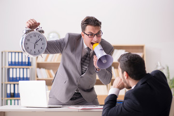 Angry boss shouting at his employee