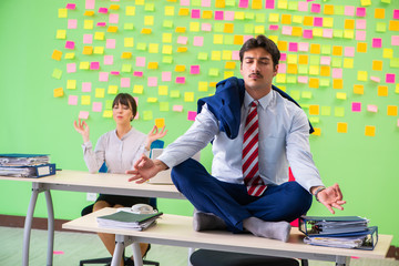 Man and woman in the office with many conflicting priorities in 