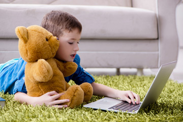 Little boy surfing internet on laptop