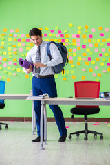 Man in the office with many conflicting priorities preparing go 