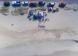 Aerial view of a group of people camping on the beach