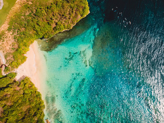 Aerial view of tropical beach with crystal turquoise ocean in Bali, holiday sandy beach, blue lagoon