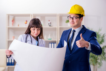 Doctor discussing new hospital plan with architect