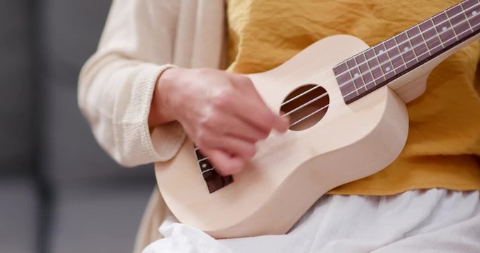 Woman play ukulele