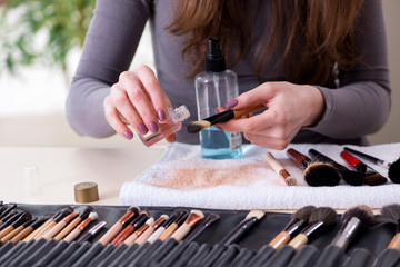Fototapeta na wymiar Make-up artist preparing brushes for work