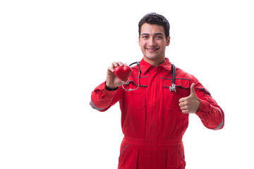 Young handsome man with stethoscope and heart  in red uniform is