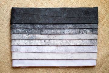Fabric stack of assorted grey scale patterns for sewing and quilting