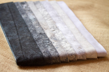 Fabric stack of assorted grey scale patterns for sewing and quilting