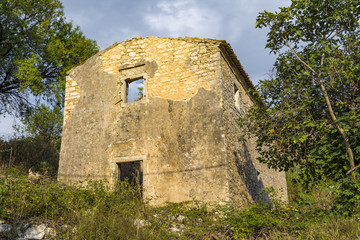 Fototapeta na wymiar Old abandoned stone-built house in Old Perithia at Pantokrator Mountain, Corfu Island, Greece