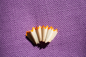 Colorful pencil shavings on plain background