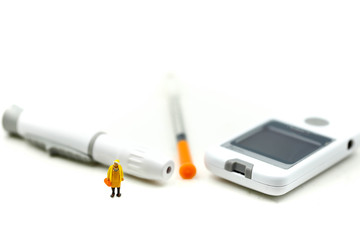 Miniature people : Doctor and patient with Glucose meter diabetes test and Syringe with measuring tape,concept of diabetes, healthy lifestyles and nutrition