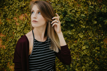 Cute Attractive Blonde Young Woman in Stripes Smiling and Posing for Camera Downtown 