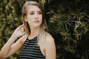 Cute Attractive Blonde Young Woman in Stripes Smiling and Posing for Camera Downtown 