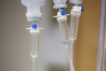 Close up saline bottle and saline drop with blur background. Illness treatment. Health insurance...