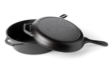 Empty, clean black cast iron pan or dutch oven over white