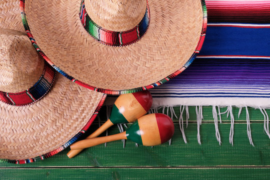 Mexico cinco de mayo fiesta carnival traditional green wood background border mexican sombrero serape rug or blanket photo