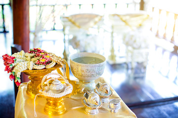 Thai wedding accessory for cultural wedding ceremony, luxury chair for bride and groom, golden tray with pedestal and the others. image for wedding objects, copy space and advertisement.