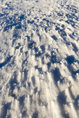 snow-covered soil surface close up ,