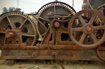 Fototapeta na wymiar Gears and belt in rusty old machine