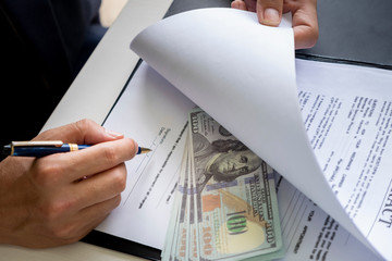 anti bribery and corruption concepts, money offered in file, giving money in file while making deal...