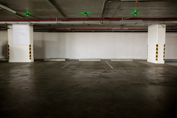 parking garage underground interior with blank billboard.Empty space car park interior at afternoon.Indoor parking lot.interior of parking garage with car and vacant parking lot in building.