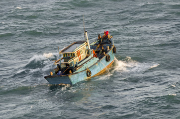 Fishing boat in a stormy sea