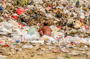 KANCHANABURI PROVINCE, THAILAND-MARCH 17: Worker working in open dump site.  Illegal landfill site  at Kanchanaburi Province on MARCH 17 , 2016 in KANCHANABURI  PROVINCE THAILAND