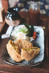 Croquette cut half and  vegetable on table