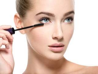 Girl makes makeup. Woman apply mascara on eyelashes