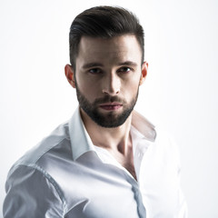 Handsome man in white shirt. Closeup portrait.