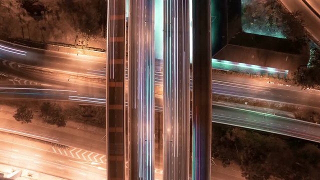 aerial shot view of traffic on freeway interchange at night. 4K UHD timelapse background