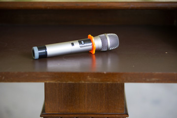 microphone placed on the podium in conference room with blur people guest background. image for...