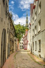 Medieval street in old Riga city with a view on ancient churches