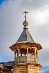Fototapeta na wymiar Wooden bell tower Orthodox Church made in the old Russian style