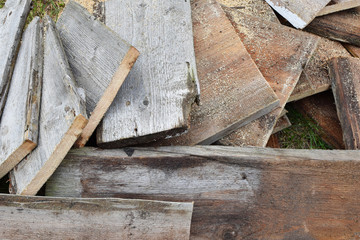 Stack of old cut natural wooden planks as abstract textured background.