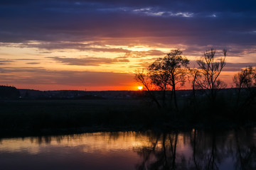 Fototapeta na wymiar Beautiful sunset over the river in spring in May 