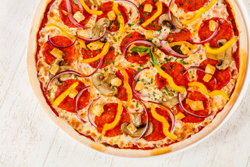 Pizza with salami and mushrooms