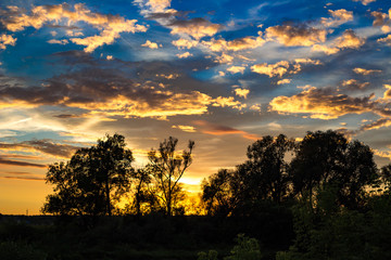 Fototapeta na wymiar Bright beautiful sunset with clouds in summer