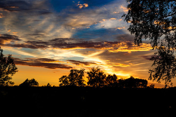 Obraz na płótnie Canvas Bright beautiful sunset with clouds in summer