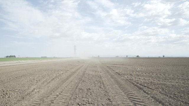 Tire tracks in leveled rural dirt field