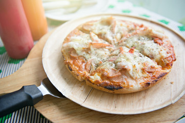 Close up seafood pizza that combined with shrimp crap and squid on wooden plate and pizza paddle