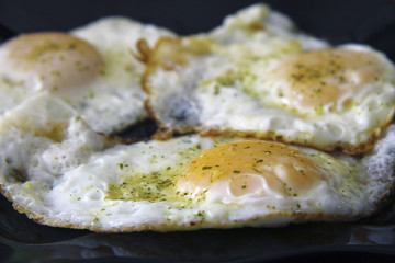 Roasted eggs on the black plate and dill over
