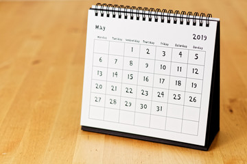 Month page: May in 2019 paper calendar with funny font on the wooden table